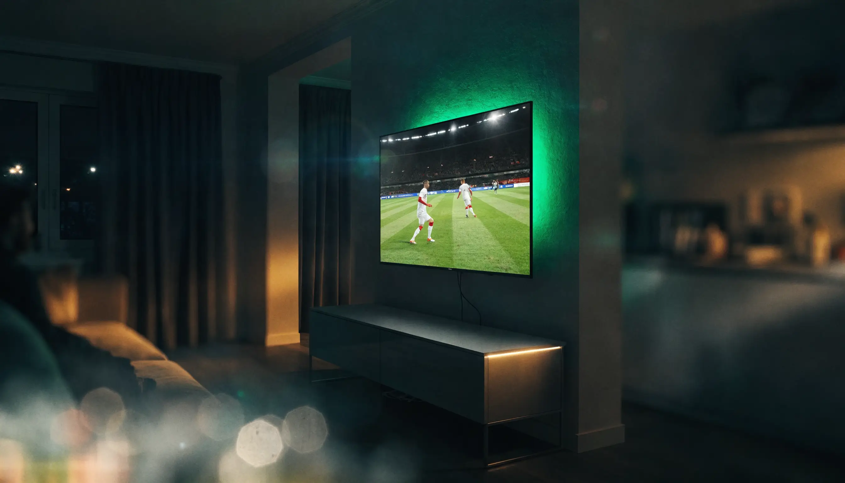 IPTV Ireland streaming a live football match on a wall-mounted smart TV in a dark living room
